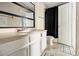 This bathroom features a vanity, mirror, and tiled flooring at 5100 Windsor Forrest Ln, Atlanta, GA 30349