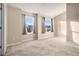 This spacious bedroom features neutral walls, plush carpeting and two windows providing natural light at 5100 Windsor Forrest Ln, Atlanta, GA 30349
