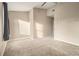 A sunlit bedroom features neutral walls, plush carpeting, and a closet entry at 5100 Windsor Forrest Ln, Atlanta, GA 30349