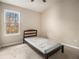 This small bedroom features neutral walls and one window providing natural light at 5100 Windsor Forrest Ln, Atlanta, GA 30349
