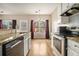 Well-lit kitchen with modern appliances, granite countertops, and tile backsplash, showcasing a functional and stylish space at 5100 Windsor Forrest Ln, Atlanta, GA 30349