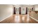 Bright living room with sleek, continuous flooring, big windows, and neutral decor, complemented by a breakfast bar at 5100 Windsor Forrest Ln, Atlanta, GA 30349