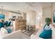 Bright, open living room with modern furniture, flowing into a kitchen with stainless steel appliances and breakfast bar at 5100 Windsor Forrest Ln, Atlanta, GA 30349