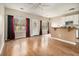 Open-concept living area with natural light, wood-look flooring, and a breakfast bar connecting to the kitchen space at 5100 Windsor Forrest Ln, Atlanta, GA 30349