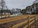 Farmhouse exterior view with a wooden fence and landscaping at 2259 County Line Rd, Acworth, GA 30101