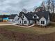 Modern farmhouse exterior with gray roof, white siding, and stone accents at 2259 County Line Rd, Acworth, GA 30101