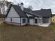 Back of house showcasing covered patio and landscaping at 2259 County Line Rd, Acworth, GA 30101