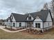 Stunning farmhouse exterior boasts a charming front porch and modern gray roof at 2259 County Line Rd, Acworth, GA 30101