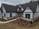 Modern farmhouse exterior with gray roof, white siding, and stone accents at 2259 County Line Rd, Acworth, GA 30101