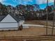 Side view of farmhouse showcasing detached garage and landscaping at 2259 County Line Rd, Acworth, GA 30101