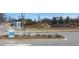 Community entrance with attractive stone signage and landscaping with a black fence in the background at 6055 Spring Way, Stonecrest, GA 30038