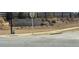Stone entrance sign for Highland Park surrounded by landscaping and a black fence at 6055 Spring Way, Stonecrest, GA 30038