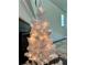 A small decorated tree near the fireplace adds a cozy touch at 7665 Easton Valley Ln, Cumming, GA 30028