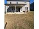 Covered patio with concrete floor and white columns outside the house at 7665 Easton Valley Ln, Cumming, GA 30028