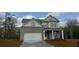 Charming two-story home with a brick facade, attached two-car garage, and well-maintained lawn at 6061 Spring Way, Stonecrest, GA 30038