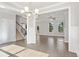 Bright and airy living room featuring hardwood floors, large windows, and modern lighting fixture at 6061 Spring Way, Stonecrest, GA 30038