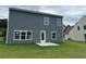 View of the house's backyard featuring a gray siding and a small concrete patio at 3290 Forest Green Dr, Douglasville, GA 30135