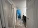 Hallway view with bathroom featuring a shower and a glimpse into the main bedroom at 3290 Forest Green Dr, Douglasville, GA 30135