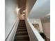 Carpeted staircase with white railing leading to the upper level of the home at 3290 Forest Green Dr, Douglasville, GA 30135
