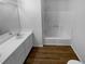 Bright bathroom features a white vanity with double sinks and a shower-tub combination at 320 Rebecca Lake Way, Fairburn, GA 30213