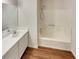 Bright bathroom featuring a shower over tub and single sink vanity at 320 Rebecca Lake Way, Fairburn, GA 30213