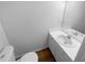 Clean bathroom featuring a white vanity and toilet with wood-look flooring at 320 Rebecca Lake Way, Fairburn, GA 30213