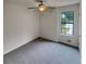 Bright bedroom with a ceiling fan, large window, and neutral carpet at 320 Rebecca Lake Way, Fairburn, GA 30213