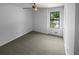 Clean bedroom with neutral carpet, ceiling fan, and a window with a view at 320 Rebecca Lake Way, Fairburn, GA 30213