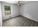 Cozy bedroom with neutral carpet, ceiling fan, and bright window at 320 Rebecca Lake Way, Fairburn, GA 30213