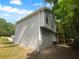 Side view of a home featuring light gray siding and a small elevated back porch at 320 Rebecca Lake Way, Fairburn, GA 30213