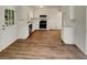 Clean white kitchen featuring stainless steel appliances and wood-look flooring at 320 Rebecca Lake Way, Fairburn, GA 30213