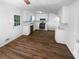 Bright kitchen featuring white cabinets, stainless steel appliances, and wood-look flooring at 320 Rebecca Lake Way, Fairburn, GA 30213