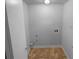 Compact laundry room with tile floor and essential hookups at 320 Rebecca Lake Way, Fairburn, GA 30213