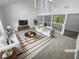 Bright living room with vaulted ceilings, comfortable seating and a large window for natural light at 320 Rebecca Lake Way, Fairburn, GA 30213