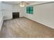 Spacious living room features neutral carpet, fireplace and a bright window at 320 Rebecca Lake Way, Fairburn, GA 30213
