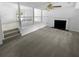 Open concept living area with neutral carpet, fireplace, and railing overlooking another room at 320 Rebecca Lake Way, Fairburn, GA 30213