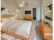 Staged main bedroom with a ceiling fan, light wood furniture and ensuite at 320 Rebecca Lake Way, Fairburn, GA 30213