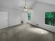 Spacious carpeted bedroom features great natural light and neutral wall color at 320 Rebecca Lake Way, Fairburn, GA 30213