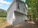 This home features durable siding, a view of the back deck, and mature shade trees at 320 Rebecca Lake Way, Fairburn, GA 30213