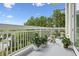 Stylish condo balcony showcases white railing, potted plants, decor, and picturesque outdoor scenery at 2500 Peachtree Nw Rd # 405S, Atlanta, GA 30305