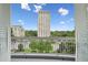 Balcony view of a building and trees under a partly cloudy sky at 2500 Peachtree Nw Rd # 405S, Atlanta, GA 30305