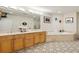 Bathroom with double sinks, large mirrors, a soaking tub, and designer tile at 2500 Peachtree Nw Rd # 405S, Atlanta, GA 30305