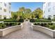 Professionally landscaped courtyard with hardscaped walkway and manicured shrubs and flowers at 2500 Peachtree Nw Rd # 405S, Atlanta, GA 30305