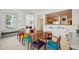 Bright dining area with a large wooden table, colorful chairs, and an open layout to the kitchen at 2500 Peachtree Nw Rd # 405S, Atlanta, GA 30305