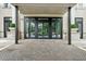 Close-up of grand entrance doors with brick-paved walkway at 2500 Peachtree Nw Rd # 405S, Atlanta, GA 30305