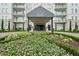 Elegant building entrance with manicured flower beds and covered portico at 2500 Peachtree Nw Rd # 405S, Atlanta, GA 30305