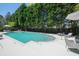 Outdoor pool with sun loungers and tables, surrounded by lush greenery for a serene retreat at 2500 Peachtree Nw Rd # 405S, Atlanta, GA 30305