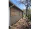 Yard on side of house with exterior wall with windows boarded up at 15 Johnson Nw Rd, Atlanta, GA 30318