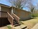 Exterior of house with back steps and yard with windows boarded up at 15 Johnson Nw Rd, Atlanta, GA 30318