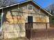 Exterior view of home showing back door and boarded up windows at 15 Johnson Nw Rd, Atlanta, GA 30318